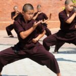 A group of monks from Nepal put on a kung fu demonstration with sword techniques in front of an enthusiastic audience